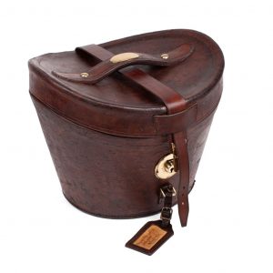 Toasted hazelnut leather hat box with kerbstone buckle closure, brass fittings.Signature by "A. J. WHITE. HATTER.