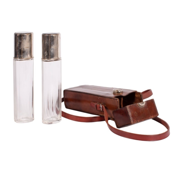 Set of two small glass bottles with silver alpaca glass stopper and brown cowhide leather cover